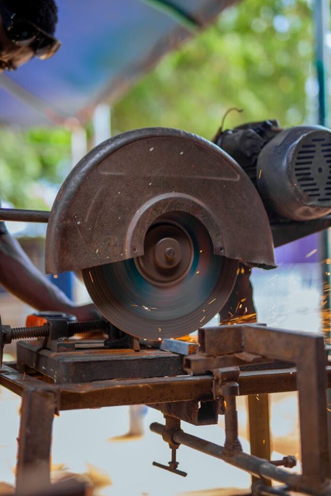 Close-up of a chop saw cutting metal with sparks. Industrial metalwork setting, dynamic action shot.